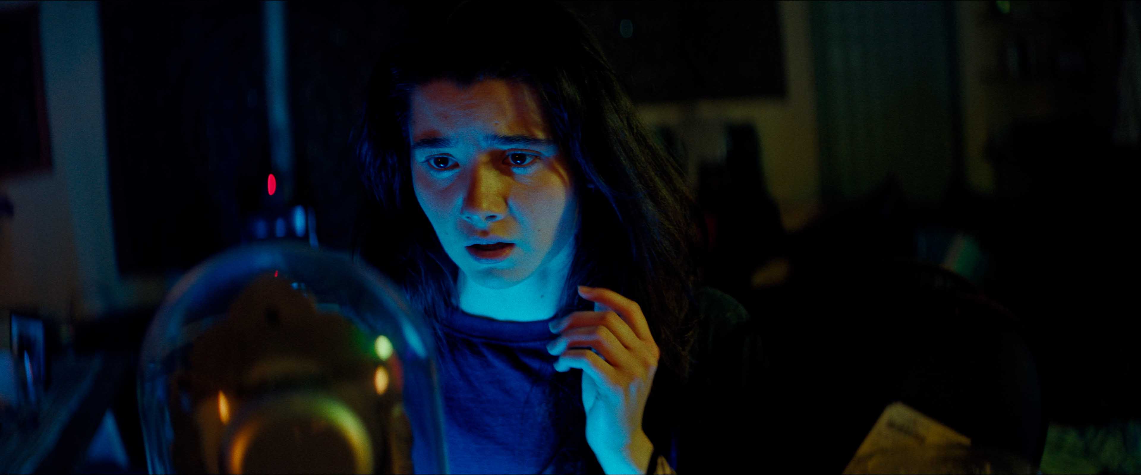 Silver Porsche 911 GT3 racing up a mountain road, motion-blurred asphalt and dramatic cloudscape in the background.