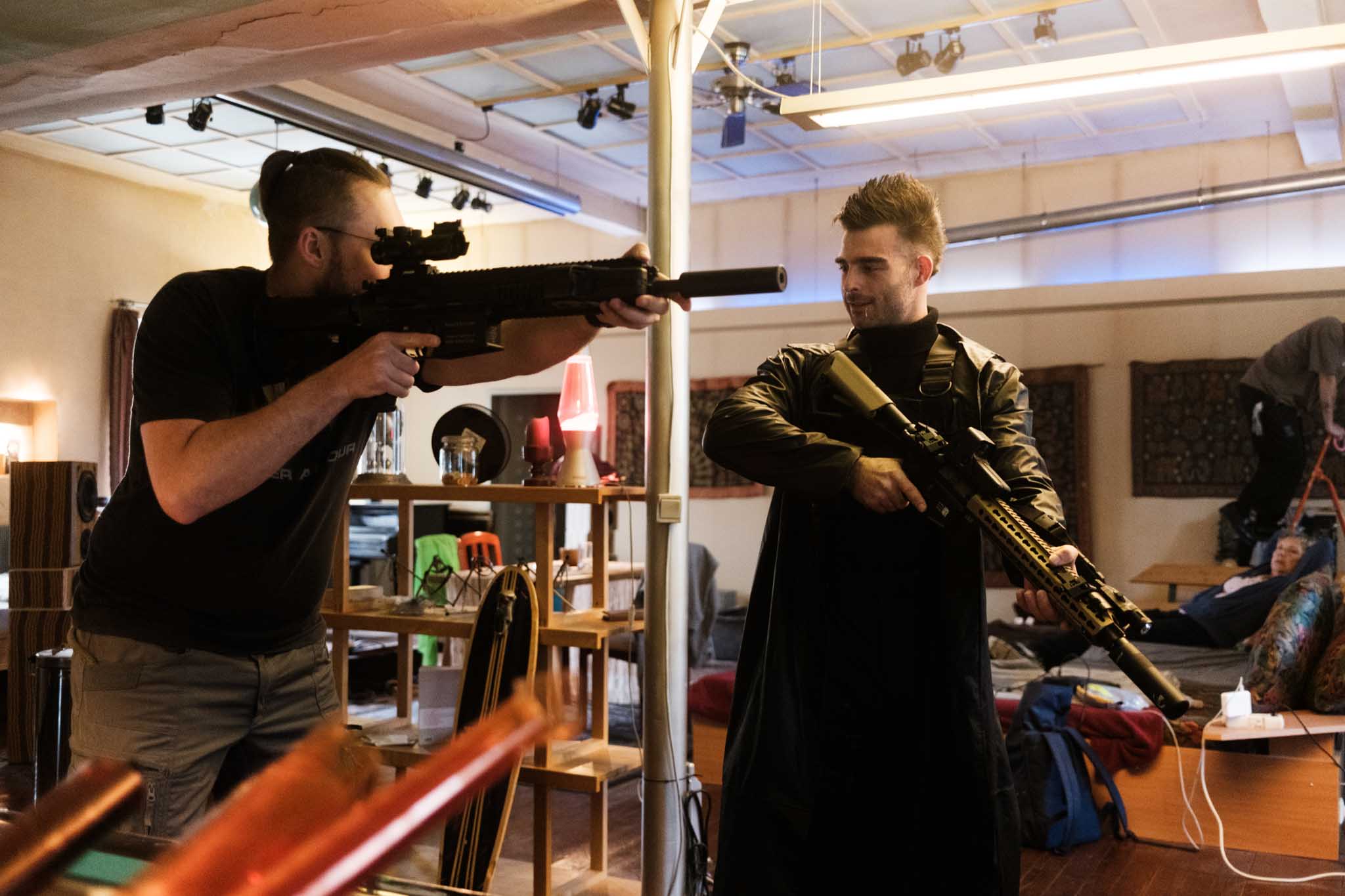 Silver Porsche 911 GT3 racing up a mountain road, motion-blurred asphalt and dramatic cloudscape in the background.