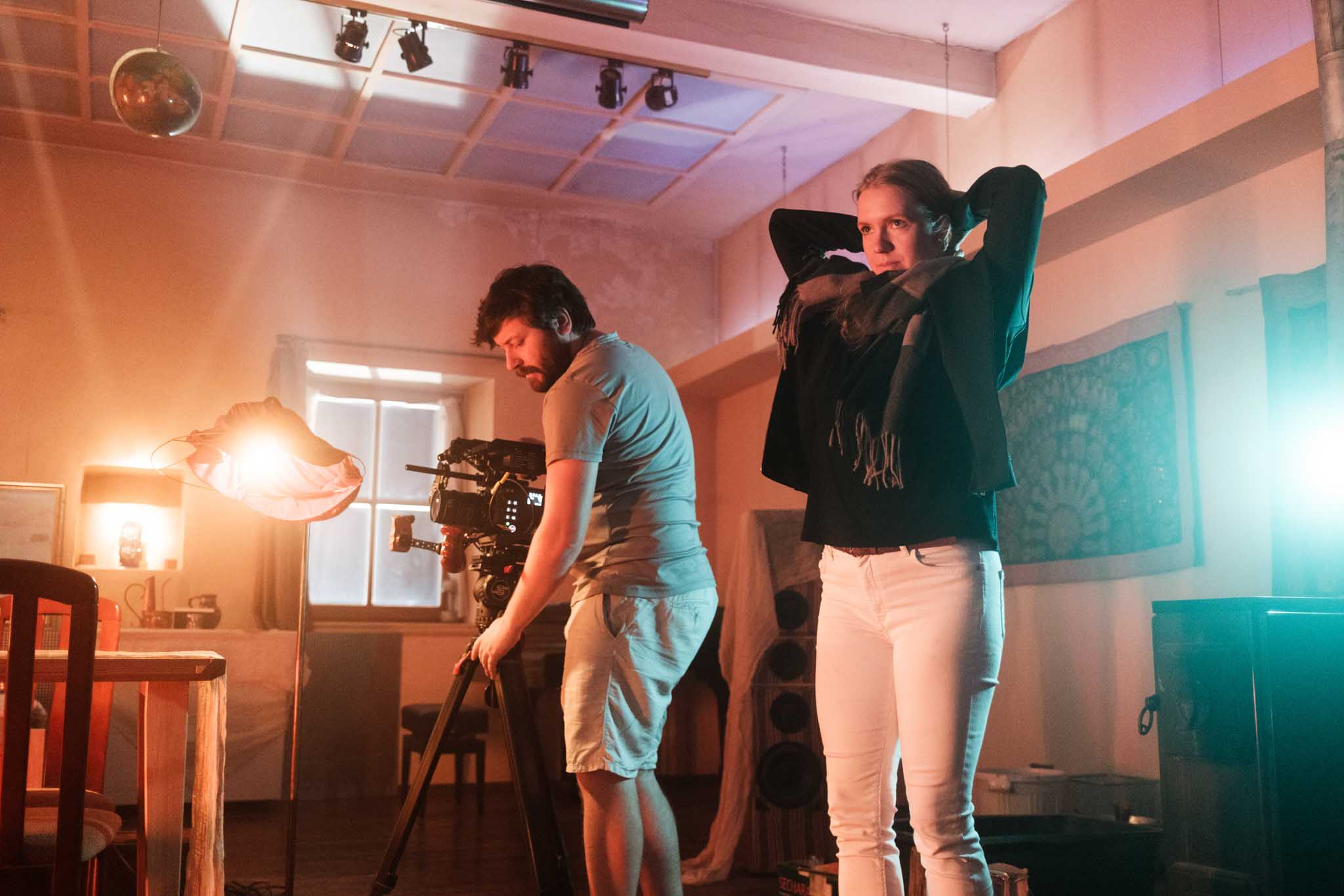 Macro detail: red-lit paddle shifter on a steering wheel, silhouetted against dark blue background.