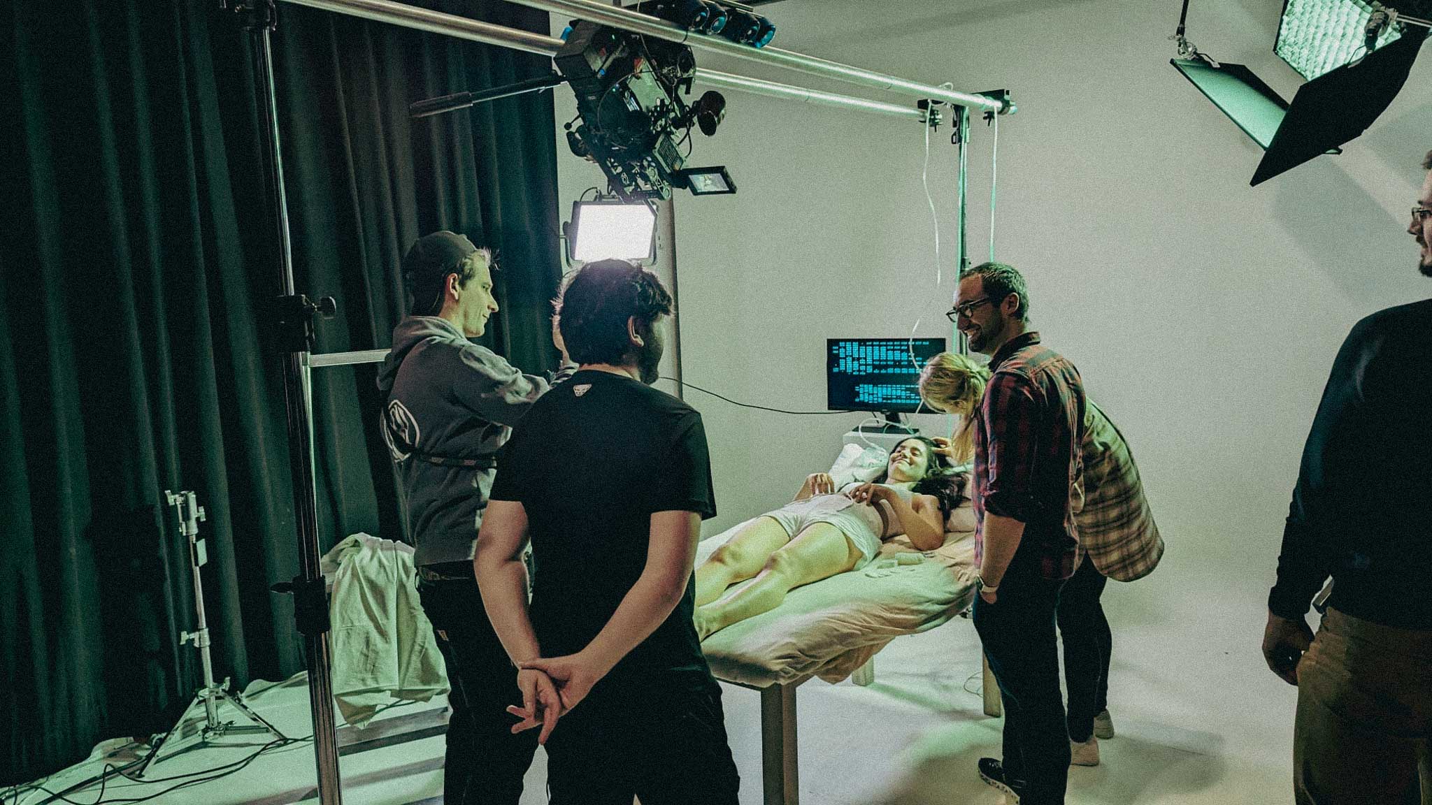 Close-up of a Porsche 911 GT3 rear wing and glowing LED taillight, bathed in deep red tunnel light.