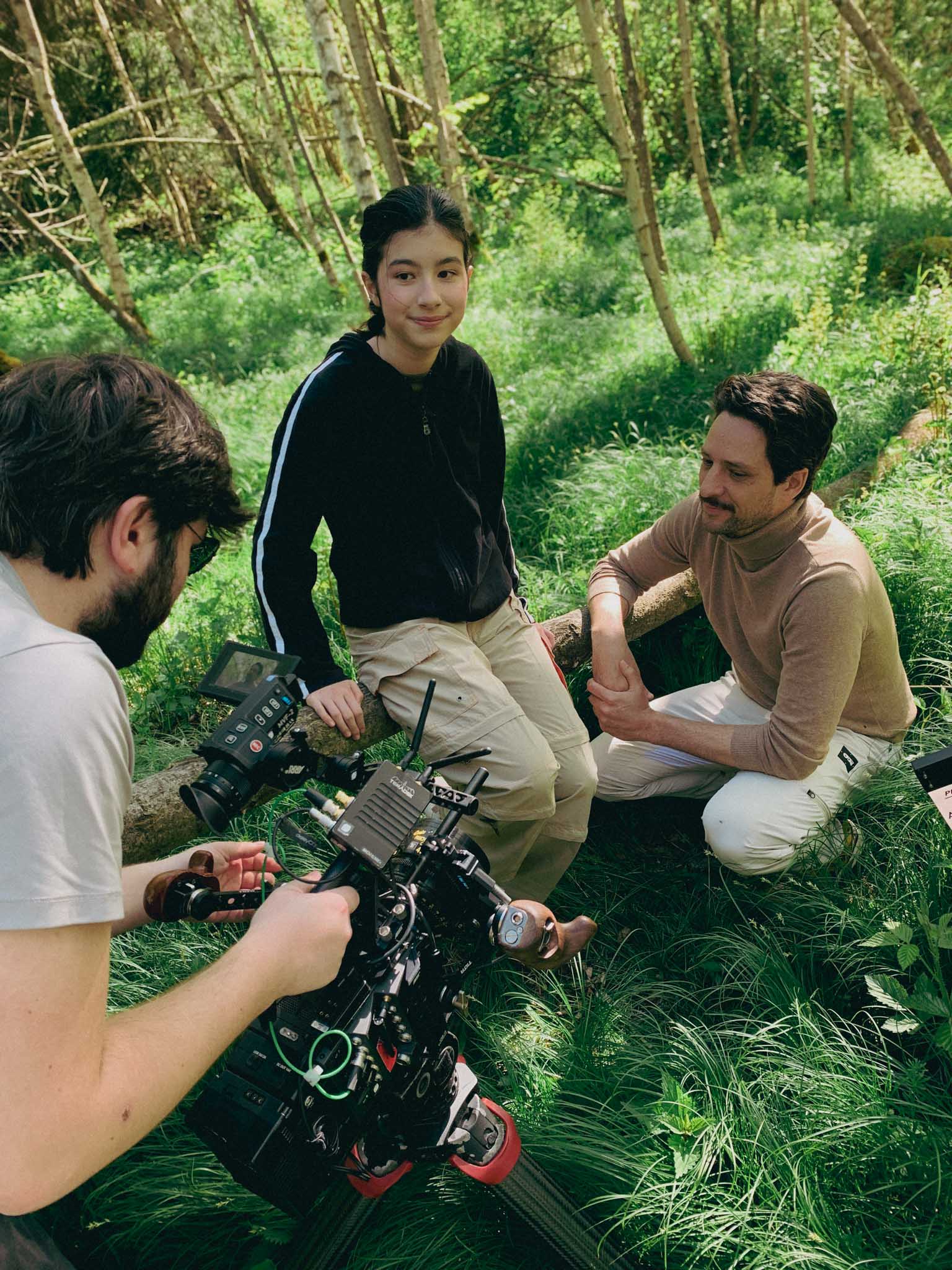 Close-up of a Porsche 911 GT3 rear wing and glowing LED taillight, bathed in deep red tunnel light.