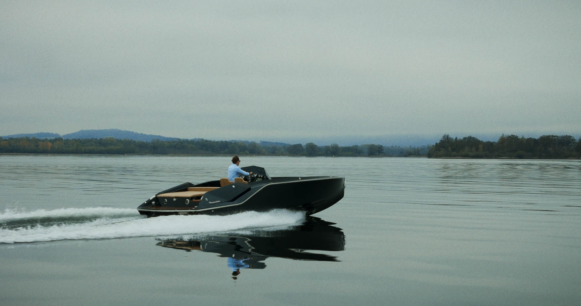 Macro detail: red-lit paddle shifter on a steering wheel, silhouetted against dark blue background.