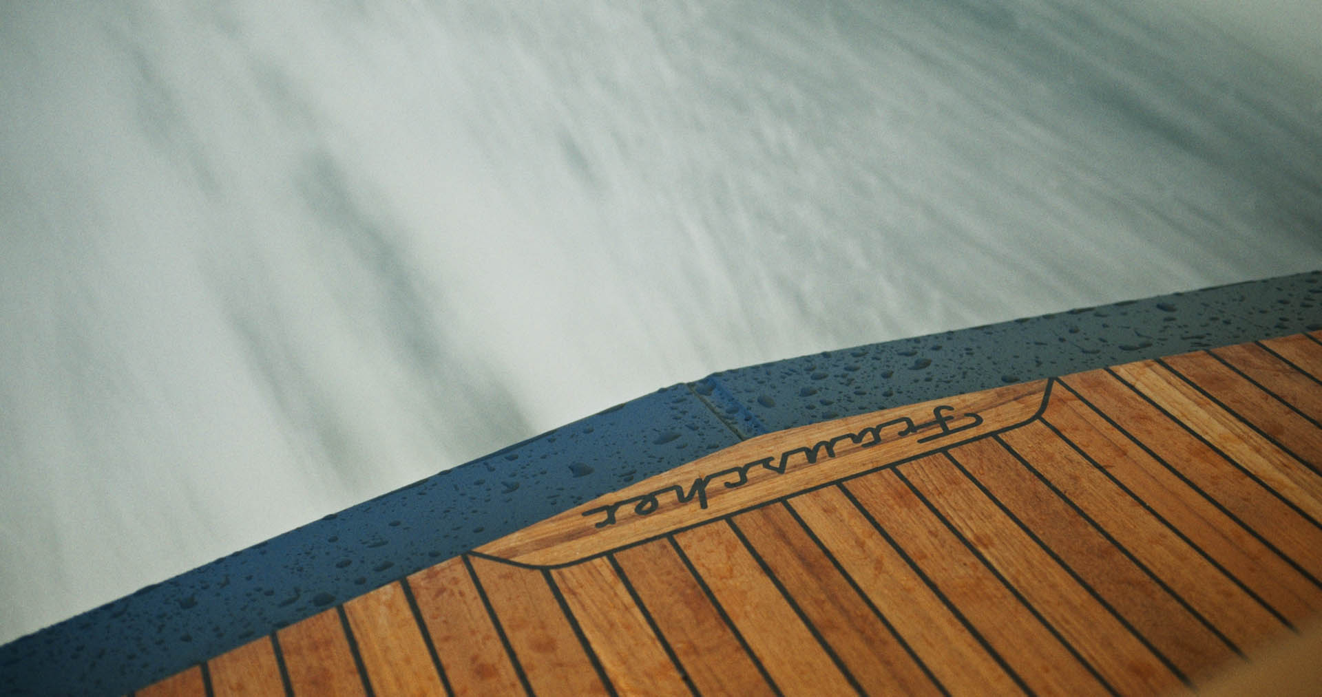 Silhouette of a helmeted racing driver at dusk, mountain skyline faintly visible under violet sky.